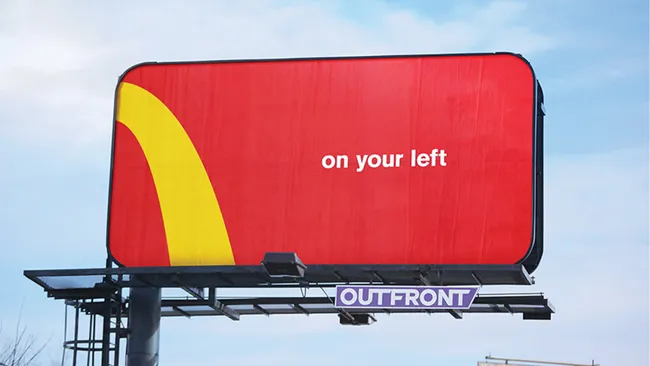 A red and yellow McDonald's billboard ad showing the simple text 